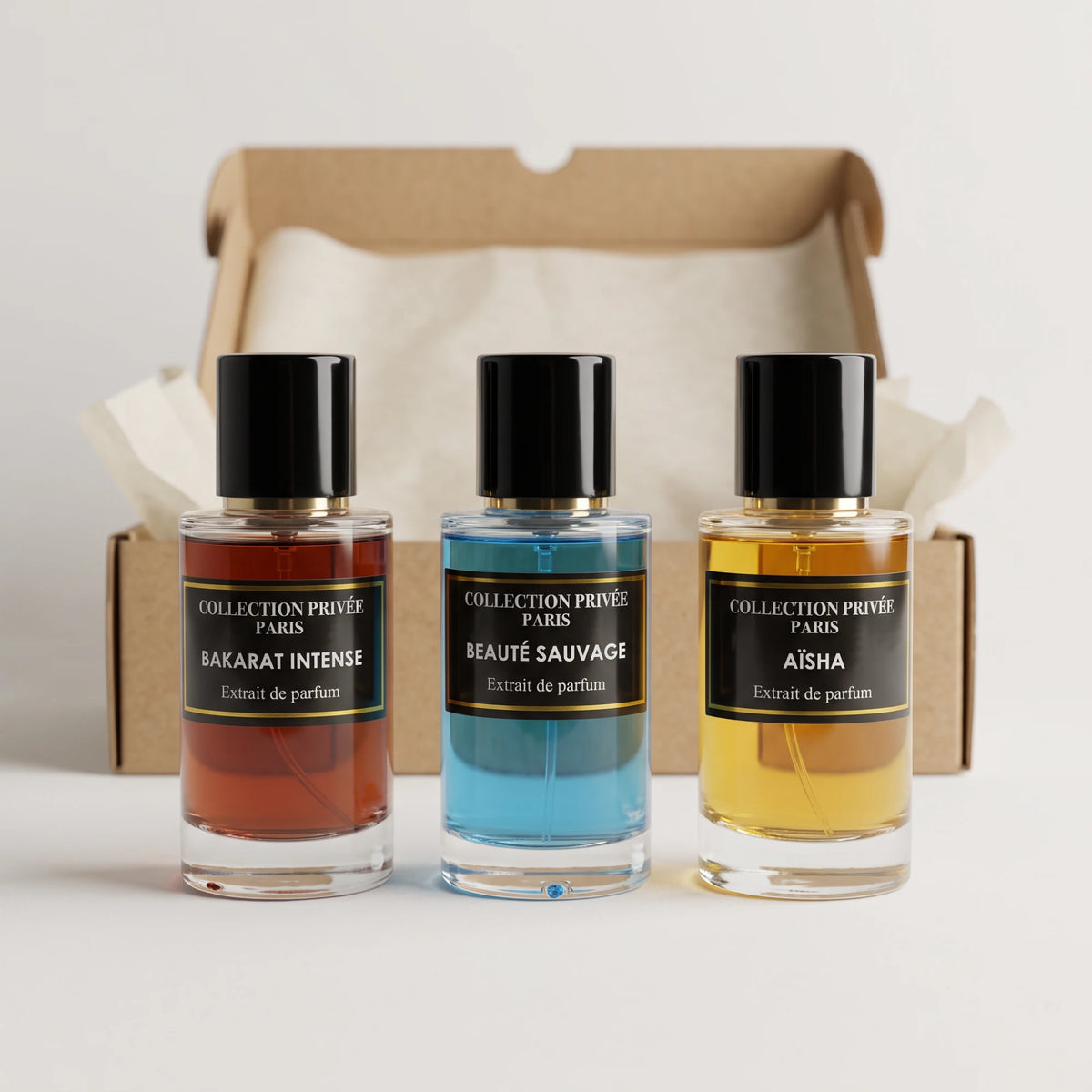 Box 3 parfums – Bakarat Intense, Beauté Sauvage et Aïsha devant leur carton d'envoi